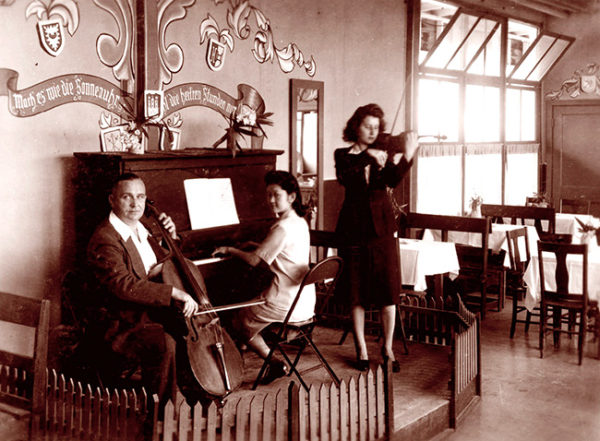 German U.S. resident playing cello, a Japanese U.S. resident on piano, and a German resident of Latin America with violin in the Crystal City alien internment camp